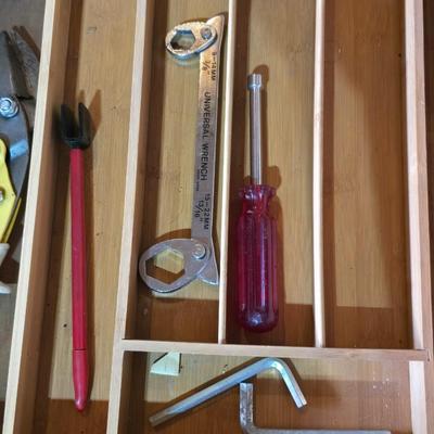 Wood organizing tray full of a variety of handtools