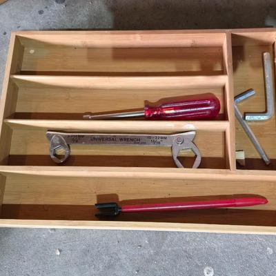Wood organizing tray full of a variety of handtools