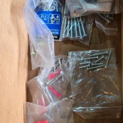 Assortment of home hardware - new caster wheels - screws - nails - Large rat traps - new in the bag hardware