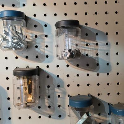 Pegboard mounted lidded containers with hardware