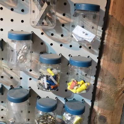 Pegboard mounted lidded containers with hardware