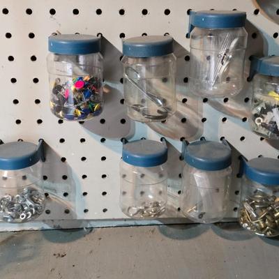Pegboard mounted lidded containers with hardware