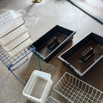 Grouping of storage baskets and racks and a multi-use metal organizer rack