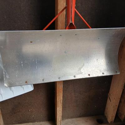 Two snow shovels - one metal - one plastic and a lidded bucket for ice melt