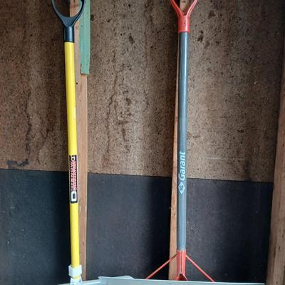 Two snow shovels - one metal - one plastic and a lidded bucket for ice melt