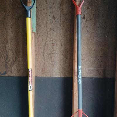 Two snow shovels - one metal - one plastic and a lidded bucket for ice melt