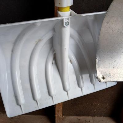 Two snow shovels - one metal - one plastic and a lidded bucket for ice melt