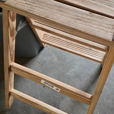 Wood 2 foot step ladder and a grey plastic trashcan