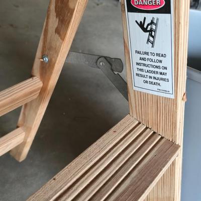 Wood 2 foot step ladder and a grey plastic trashcan