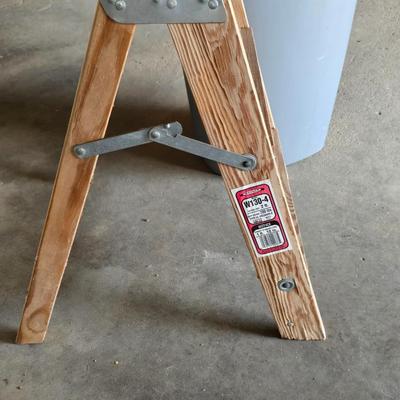 Wood 2 foot step ladder and a grey plastic trashcan