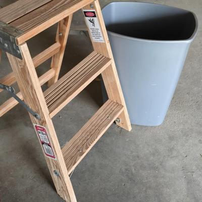 Wood 2 foot step ladder and a grey plastic trashcan