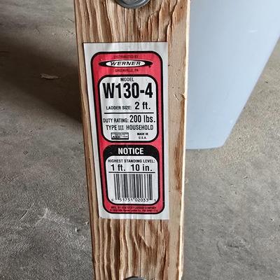 Wood 2 foot step ladder and a grey plastic trashcan