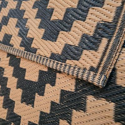 Black and brown reversible outdoor area rug 69" x 47"