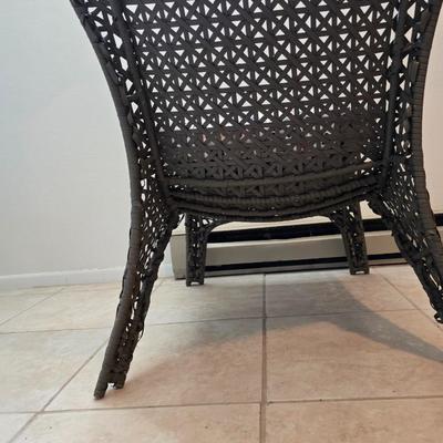 Brown woven Faux rattan lounge chair indoor/outdoor with a throw pillow