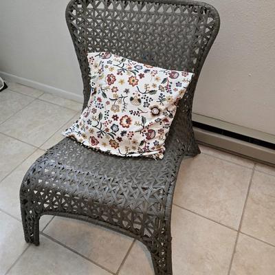 Brown woven Faux rattan lounge chair indoor/outdoor with a throw pillow