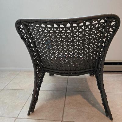 Brown woven Faux rattan lounge chair indoor/outdoor with a throw pillow