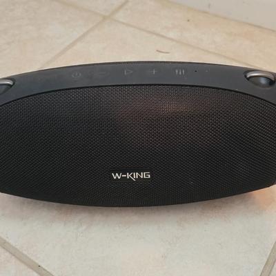 Nice W-KING Bluetooth Speaker with accessories and charging cord.