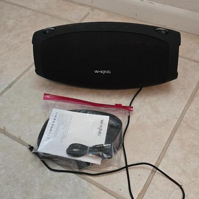 Nice W-KING Bluetooth Speaker with accessories and charging cord.