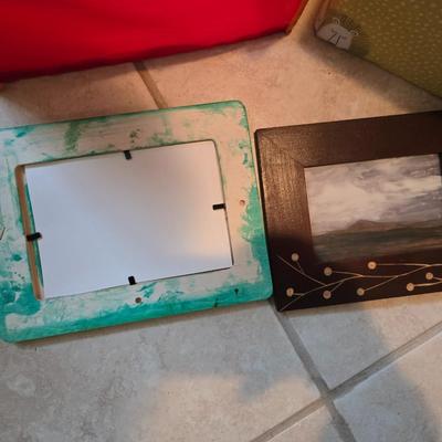 Three canvas like storage baskets and two picture frames
