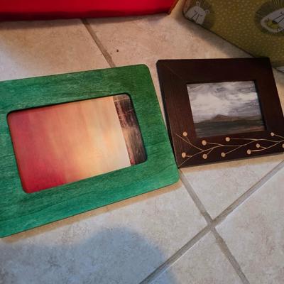 Three canvas like storage baskets and two picture frames