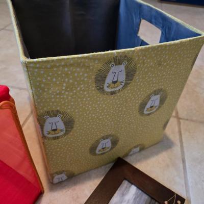 Three canvas like storage baskets and two picture frames