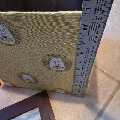 Three canvas like storage baskets and two picture frames