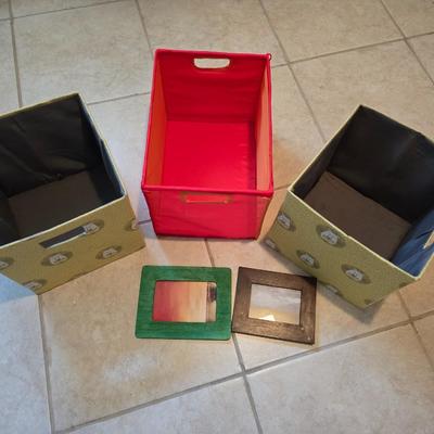 Three canvas like storage baskets and two picture frames
