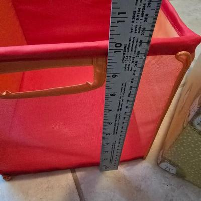 Three canvas like storage baskets and two picture frames