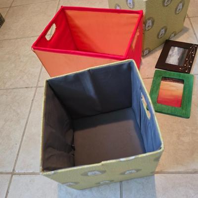 Three canvas like storage baskets and two picture frames