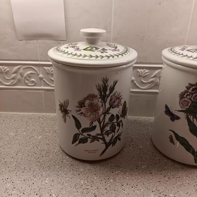 2 PORTMEIRION BOTANIC GARDENS CANISTERS AND AN ENAMEL CONTAINER WITH FAUX FLOWERS