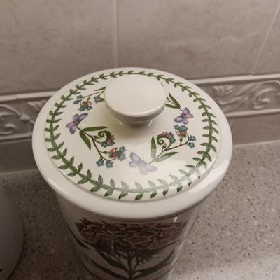 2 PORTMEIRION BOTANIC GARDENS CANISTERS AND AN ENAMEL CONTAINER WITH FAUX FLOWERS
