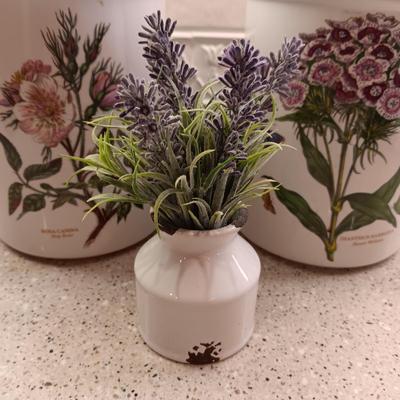 2 PORTMEIRION BOTANIC GARDENS CANISTERS AND AN ENAMEL CONTAINER WITH FAUX FLOWERS