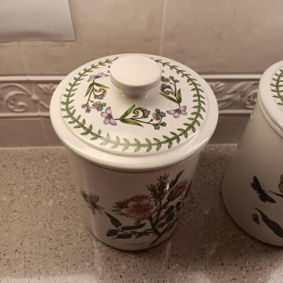 2 PORTMEIRION BOTANIC GARDENS CANISTERS AND AN ENAMEL CONTAINER WITH FAUX FLOWERS