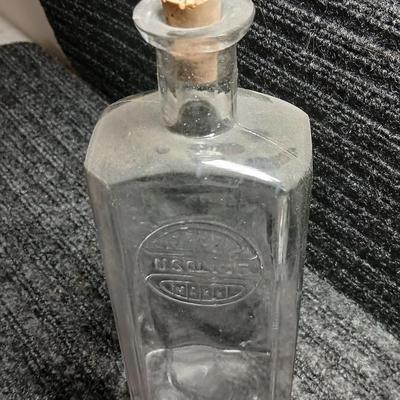 Antique embossed bottle with cork stopper
