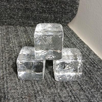 Empty Glass Frosted bottle with horse rear stopper and three glass ice cubes / clear glass cubes