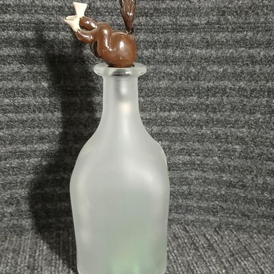Empty Glass Frosted bottle with horse rear stopper and three glass ice cubes / clear glass cubes