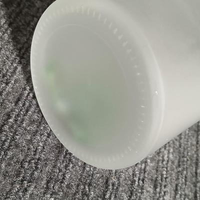 Empty Glass Frosted bottle with horse rear stopper and three glass ice cubes / clear glass cubes