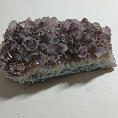 Amethyst slab and heart shaped Geode with shell looking outside.