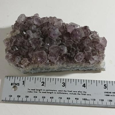 Amethyst slab and heart shaped Geode with shell looking outside.
