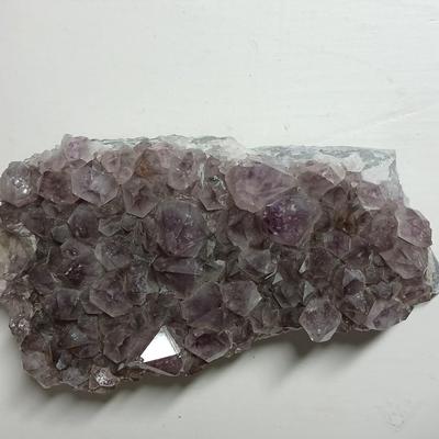 Amethyst slab and heart shaped Geode with shell looking outside.