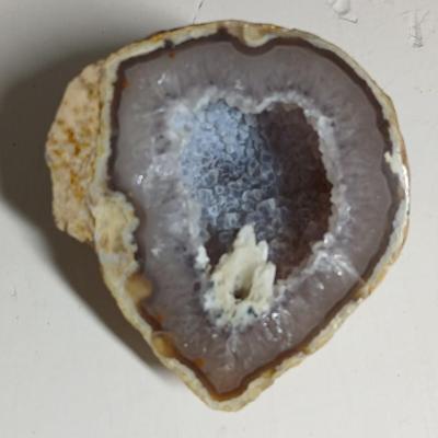 Amethyst slab and heart shaped Geode with shell looking outside.