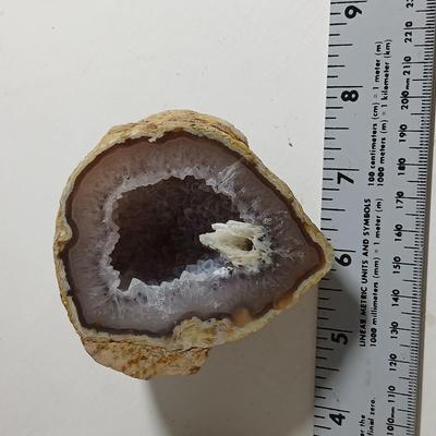 Amethyst slab and heart shaped Geode with shell looking outside.