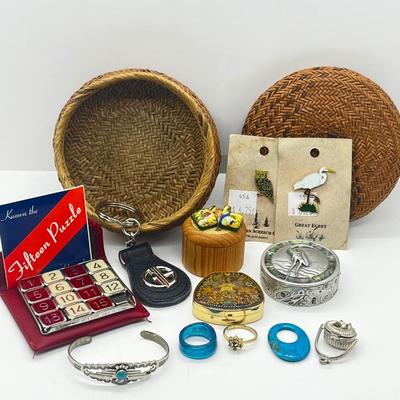 LOT 121: Pewter Nantucket Scrimshaw Basket Pendant, Dyed Oval Howlite Pendant, Two Art Glass Pendants, Fifteen Puzzle and More!