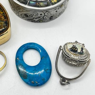 LOT 121: Pewter Nantucket Scrimshaw Basket Pendant, Dyed Oval Howlite Pendant, Two Art Glass Pendants, Fifteen Puzzle and More!