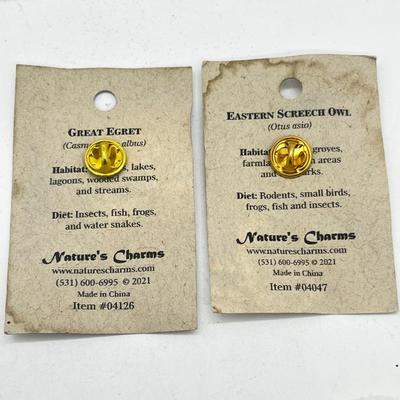 LOT 121: Pewter Nantucket Scrimshaw Basket Pendant, Dyed Oval Howlite Pendant, Two Art Glass Pendants, Fifteen Puzzle and More!