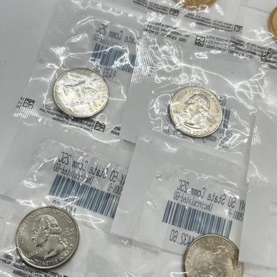 LOT 126: Four Uncirculated Sacagawea Coins and Uncirculated State Quarters