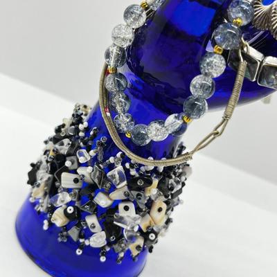 LOT 142: Collection of Unique Bracelets With Cool Fabric Box