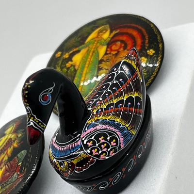 LOT 160: Russian Hand Painted Black Lacquer Brooches and Swan Trinket Box