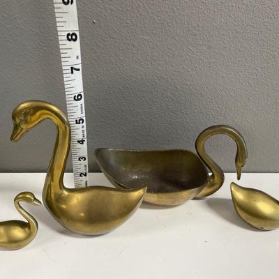 Brass swans head down