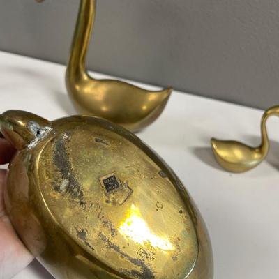 Brass swans head down